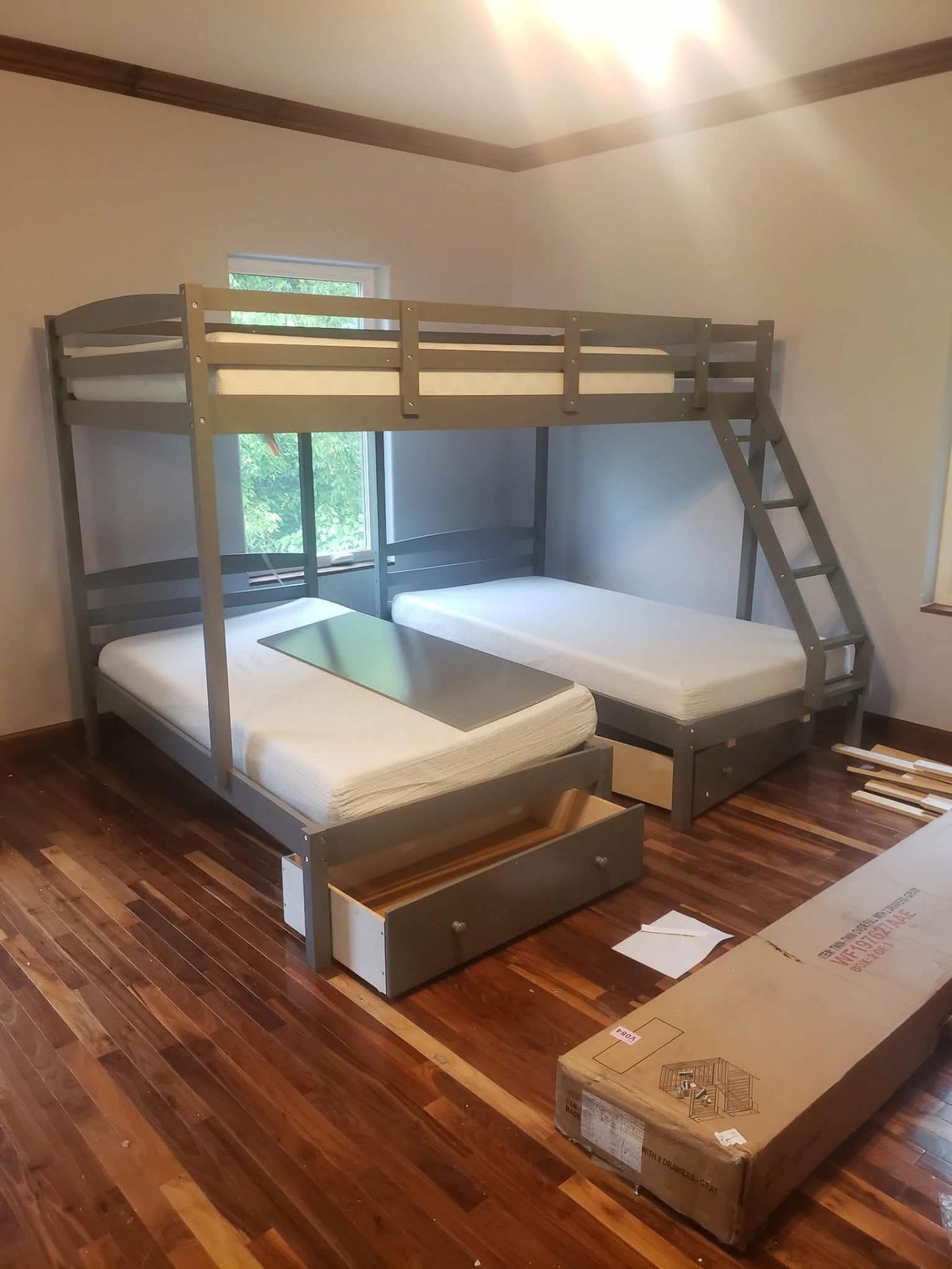 Assembled twin-over-full bunk bed with storage drawers