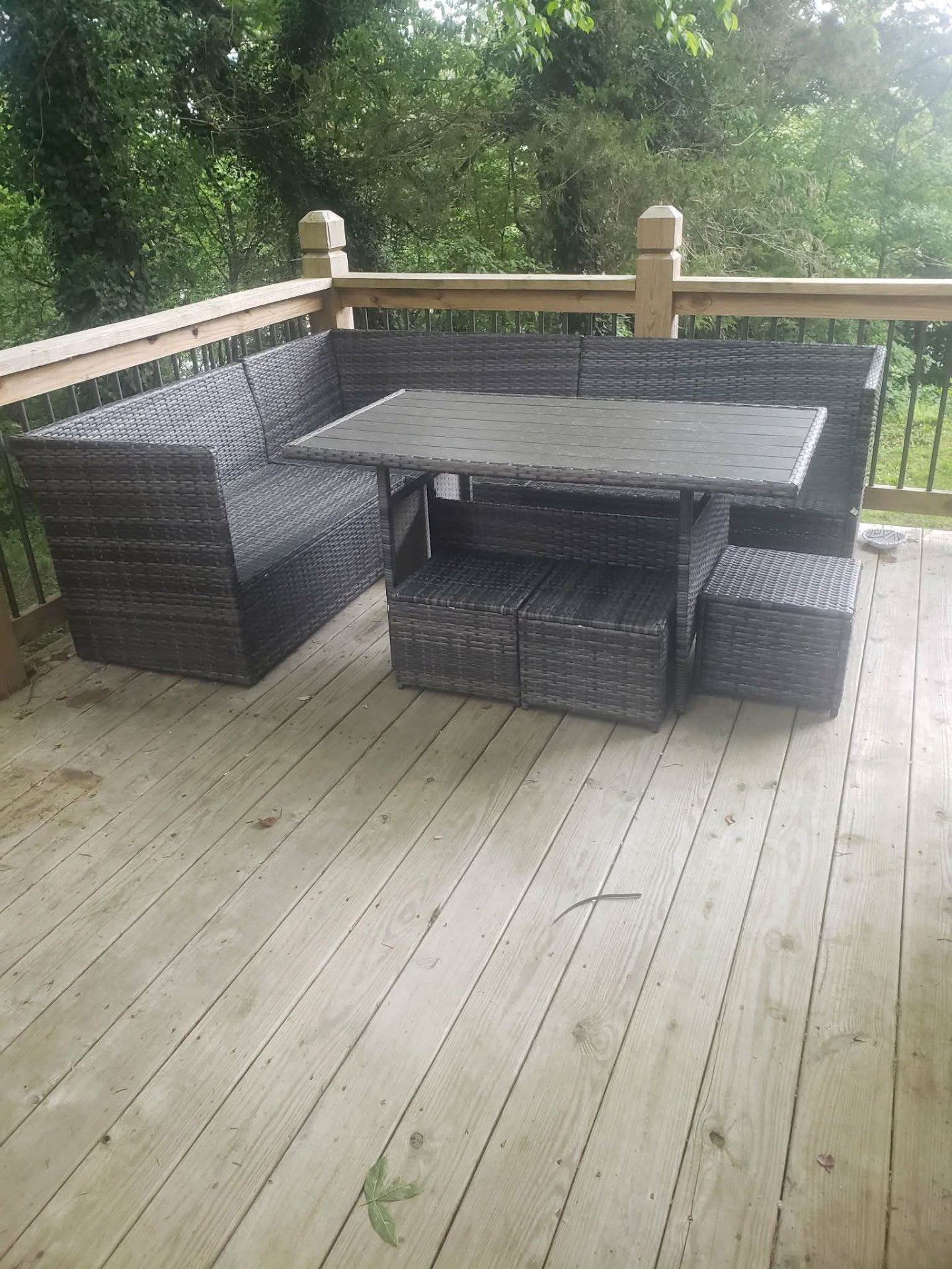Assembled patio sectional and dining set on a finished deck