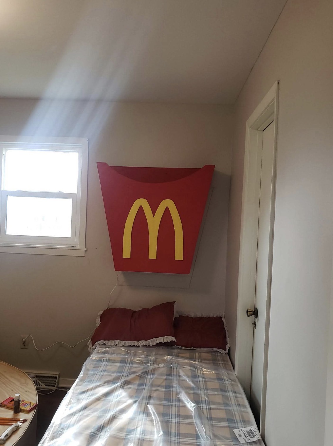 Custom hand-built oversized fry-box sign mounted in a themed bedroom